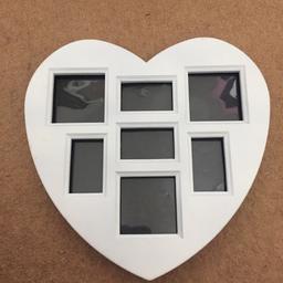 White, heart shaped photo frame with room for 7 pictures. Good condition.