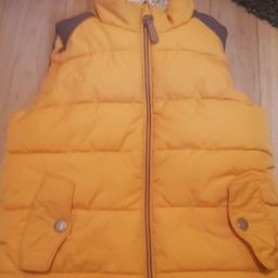 Next body warmer , mustard coloured with cream fleece lining. 
Age 4-5 years.
Plenty of wear left in it.
From a smoke and pet free home.