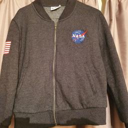 Fleece lined, size 12, American flag patch on arm and NASA space centre patch on front. Dark grey.