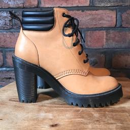 Dr. Martens heeled boots. Tan and black. 100% leather. Rubble sole and heel. Worn only a couple of times. Minor marks, reflected in price.