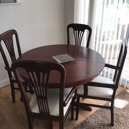 Dark wood dining table with 4 chairs (covers still on from new) few marks here and there. £30
