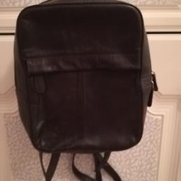 Small, black leather backpack. Lined and with zipper pocket. Excellent condition.