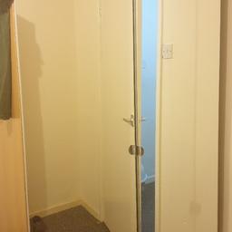 large mirrored wardrobe with top shelf and hanging rail