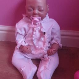 reborn doll weighs 10lb real lashes painted on strokes for the hair soft bodied selling as my daughter dosent really play with it in excellent condition paid £200 for this