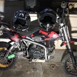 125 5 geared import pit bike, need a new chain and back break re assembling runs fine. COMES WITH TWO HELMETS.