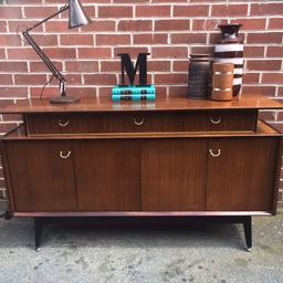 A rare and higly sought after GPLAN Tola sideboard designed in 1955 and produced between 1959-1969.

Comprising 3 cupboard & 3 drawers (middle lines with velvet)

A truly stunning piece of furniture with some evidences of previous use expected of a used vintage item.

150cm W x 46cm D x 85cm H

Would make the perfect TV stand and is sure to be a conversation starter.

Collection from Birstall WF17 West Yorkshire or delivery available within a 50 mile radius for an additional fee