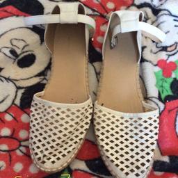 Size 7 pair of white shoes in good condition.