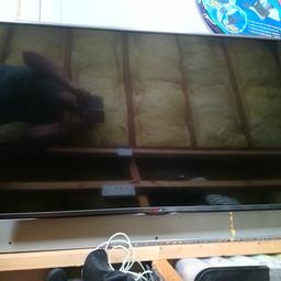 Built in freeview. No stand but comes with heavy duty bracket.