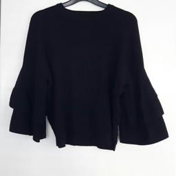 fine knit black top. ruffle balloon sleeves. size 12. pet and smoke free home