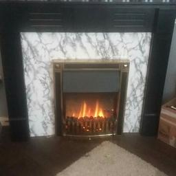 Electric fire and surround, blows hot air, surround has been painted black and could do with a touch up in places