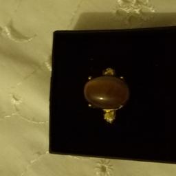 THIS RING HAS A BEAUTIFUL TIGERS EYE STONE SET WITH TWO LITTLE WHITE STONES ON THE SHOULDERS CAN SUPPLY A BOX.