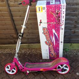 Beautiful pink space scooter. In very good condition, barely used. Can be used as a standard scooter or a space scooter. Had adjustable handlebar height and spring loaded stand. In original box with instructions and tools.