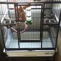 Parrot cage on stand with wheels (cage can be separated from the stand if you prefer it to be on a unit or table, includes all toys and perches excellent condition all doors and hatches can be secured