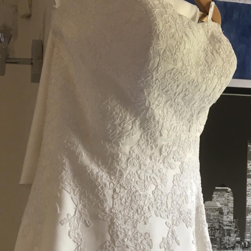 Size 10-12 Ivory wedding dress, although will fit 14-16 due to corset lace back detail.
Fantastic bodice design. (Photos don’t do this justice.)
Train removed to make a matching shawl, very elegant uncomplicated wedding dress.
Underskirt included.