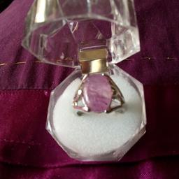 THE STONE IS A LIGHT LILAC IN COLOUR. AND THE METAL IS HALLMARKED SILVER SIZE M -N