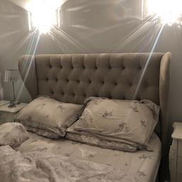 Grey buttoned king size headboard for sale. Damage to left wing as per picture.