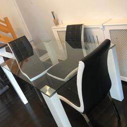 Glass top dining table with white gloss legs, 4 leather black and white dining chairs in perfect condition. (There is only 3 chairs in pictures as other one is in storage but I am selling the 4) Table In perfect condition apart from minor scratches on the inside of the legs that can easily be redone. Legs can come off dining table for easily transport. 

Collection Watford, WD18.