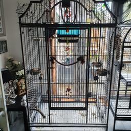Beautiful cage, large enough for a macaw or a couple of smaller parrots 
Has a top opener, and a drop front. It has a large door big enough for a macaws tail feathers