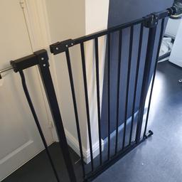 Black stair gate, wall attachment missing.