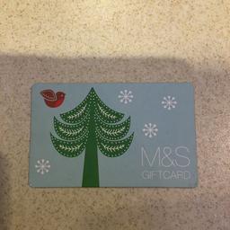 Unused gift card. 
£25 value on it. 
Christmas decoration. 
Receipt with it. You will just need a card holder.