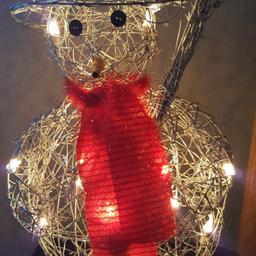 A free standing  plug in light up snowman for christmas decoration. pick up only.