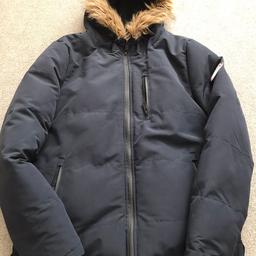 Navy blue, size medium. Very warm with faux fur trim on hood, A few tiny marks on the arm & one on the back (see photos) comes from a non smoking household.