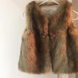 Good condition brown/neutral coloured fur style gilet with Pom Pom tie fastening at the front.