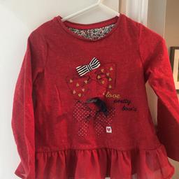 Brand new with tags never worn. Excellent condition. Red grill detailed long sleeved top. Bow detail on front.
