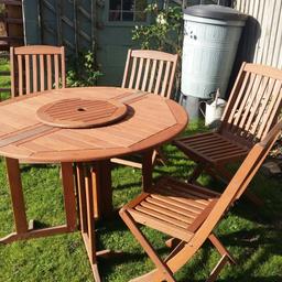 solid wood garden table and 4 folding chairs all in good condition