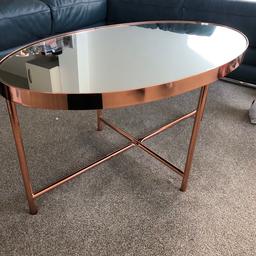 Oval shaped rose gold mirrored coffee table. Barely used. In great condition.