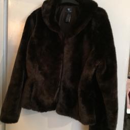 Beautiful fluffy coat never been warn size L but would say more medium.  This is not real fur please see tag