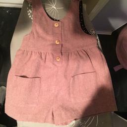 Pale pink, wooden button up fastenings/details on the chest. 
Bow detail on the shoulders. Pocket detail on the front. A little bit of bobbling on bottom but hardly noticeable (can see in last picture) good condition.