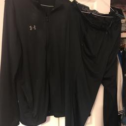 Black track suit with under armour written on the left arm and the under armour logo on the left leg -