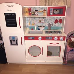 Kids play kitchen, has got “Grace” on the door which is engraved as seen in picture x