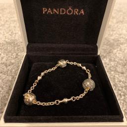 Received as a gift but never worn. Will fit a small wrist. 2 charms with it as shown in image.
