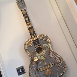 Decorated guitar in grey and gold. 
hand decorated