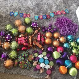 Large, medium & small baubles, glitter shiny & matte. Shiny glitter present baubles, glitter sweetie baubles, purple beads and a multicoloured Merry Christmas hanging decoration. 
All in excellent condition.