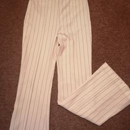 Flared pants. Never worn but has mark on inside of pants leg as shown. Postage or pick up available.