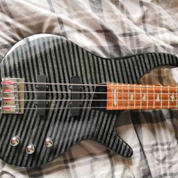 Lindo bass guitar in tiger stripe effect in good condition with new Ernie ball strings and purple strap