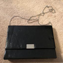 Brand-new black handbag still with tags from a smoke free home not in packaging