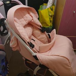 Pink my babiie comes with rain cover and carry cot fabric has been washed apart from the basket underneath due to it being unable to go in the machine to wash due it being cardboard inside the fabric that was previously damaged from it being washed doesnt affect its use hence the lower price