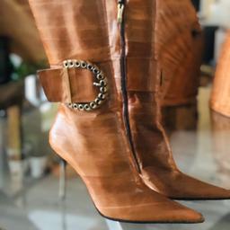 These stunning pencil healed tan leather boots are divine if I could shoe horn my tootsies into these they would be mine . Brand new never worn perfect condition . Please check my other items and reviews for confidence . Retail for £350 ! This is a perfect bargain