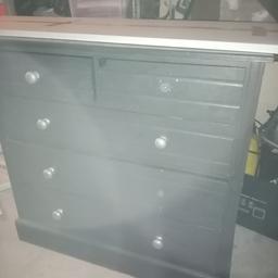 Measures 38 wide, 35 high 30 deep. This is a very heavy solid wood chest of drawers. It's painted a charcoal grey and knobs are silver 2 missing. Needs refurbing.. Marvellous up cycle project that would be gorgeous  Collection only, no delivery available.