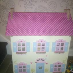 Dolls house with wooden furniture and 3 small people