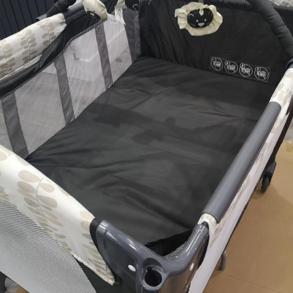 Compact travel cot with changing mat, good condition.
