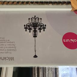 Lovely black 5 light chandelier never used. New in box. Box is damaged. Doesnt include bulbs
