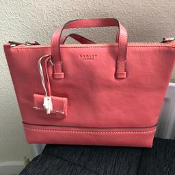 Real leather, genuine Radley Bag. Salmon pink. Hardly used. Excellent condition inside & out. With Radley dog attachment & tiny purse. Beautiful bag but just sitting in wardrobe. Cost me £90 when I first bought it. 
Includes shoulder strap. 

Collection is preferred to ensure bag arrives safely.