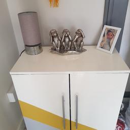 Giving away this sideboard for free.

It was initially brown in colour but I painted the outside white, grey and yellow.
The Inside is still brown.
Two shelves inside.

There is a small stain from my lamp on top..pictured above 

H 70cm
W 67cm
D 35cm