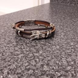 silver and leather dragons bracelet perfect condition never worn hence why I'm selling this beautiful unisex bracelet item.