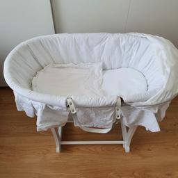 Wicker moses basket with rocking stand on white bedding including mattress and sheet. pet and smoke free home.